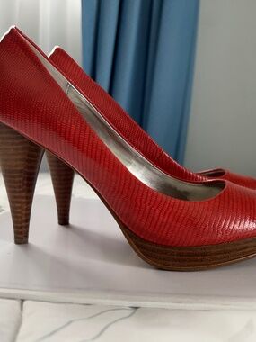 Coral / Orange red peep toe heels featuring a textured snake heel